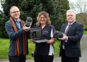 Pictured (Left to Right): Steve Tipson, Gina Reinge and Cllr Martin Watson with a pair of Apos shoes